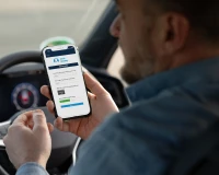 Driver using a smartphone to complete a risk assessment while seated behind the wheel