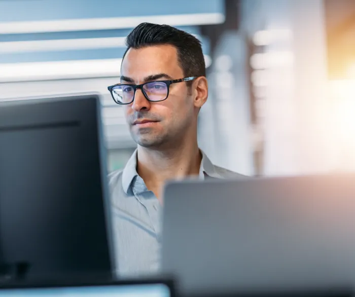 Office worker reviewing information on a computer monitor