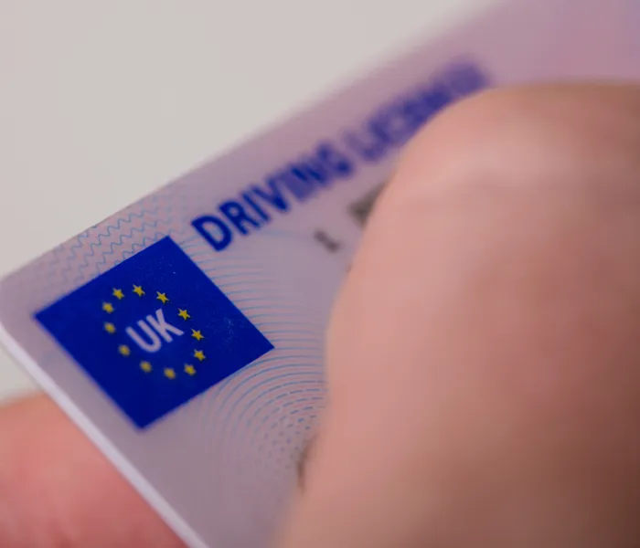 Close-up of a UK driving licence being inspected