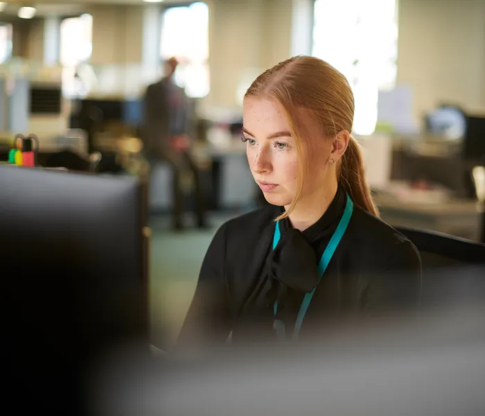 Employee working at a computer in an open-plan office