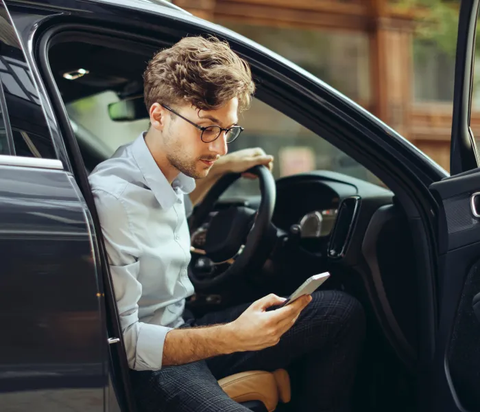 Driver using a smartphone while seated in a parked car