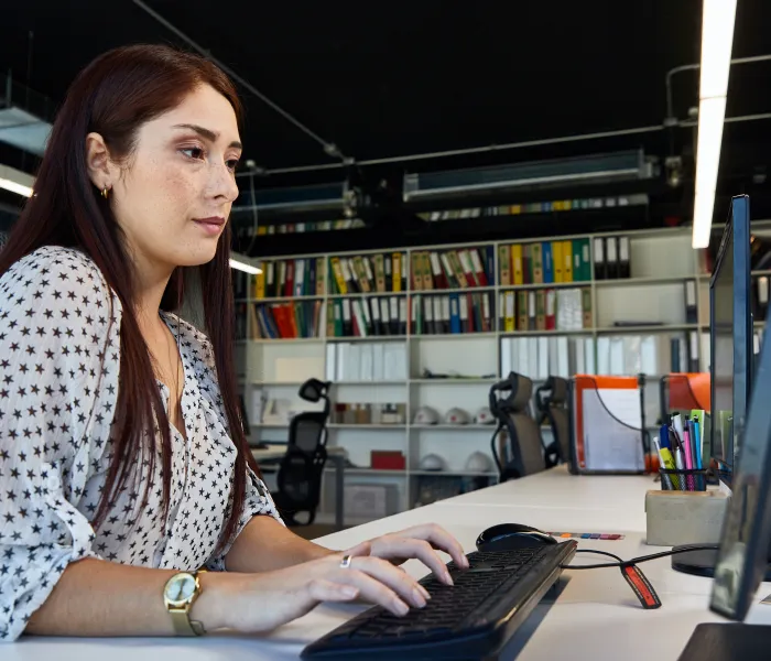 Office worker entering information at a desktop computer
